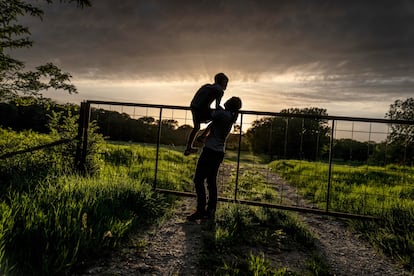 Meredith Ellis mira el ganado bajo el sol poniente junto a su hijo de seis años, en su rancho en Rosston, en el Estado de Texas (EE UU), el 20 de abril. Ellis ha visto cómo el calentamiento global está alterando su tierra. Ella lo llama una "crisis existencial", el telón de fondo de la interminable lista de tareas pendientes que conlleva la ganadería.