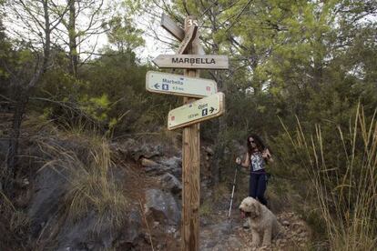 Una joven con su perro en un sendero de Málaga.