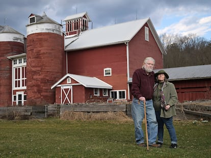 Joan and Harold Koster pose for a photo in front of a historic barn on their property, known as Itaska Valley Farm, Wednesday, March 13, 2024, in Whitney Point, N.Y. The Kosters were asked by Texas-based Southern Tier Energy Solutions to lease their land to extract natural gas by injecting carbon dioxide into the ground, which they rejected and are opposed to.