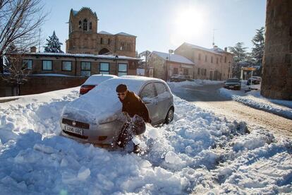 Un hombre con una pala intenta liberar su coche atrapado por la nieve en Ávila, el 8 de enero de 2018.