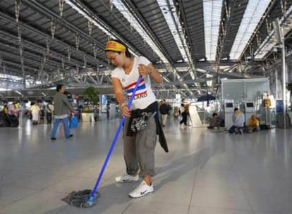 Los manifestantes limpian las instalaciones mientras se preparan para abandonar el principal aeropuerto de Bangkok