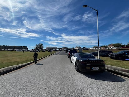 Law enforcement arrive as students are evacuated to the football stadium after the school campus was placed on lockdown at Apalachee High School in Winder, Ga., on Wednesday, Sept. 4, 2024.