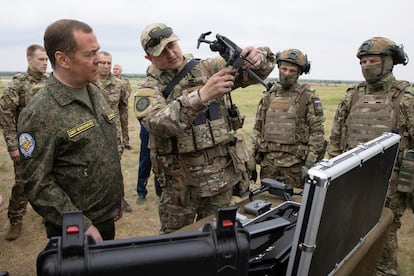 Russian Security Council Deputy Chairman and the head of the United Russia party Dmitry Medvedev, left, visits the Prudboy military training ground in the Volgograd region of Russia