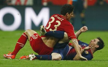 Bayern Munich&rsquo;s Mario Gomez gets up close and personal with Leo Messi in the German side&rsquo;s crushing victory Tuesday.  