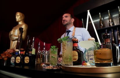 A bartender stands behind a counter with prepared drinks placed on it during a preview of the food, beverages and decor of this year's Governors Ball, the Academy's official post-Oscars celebration following the 94th Oscars ceremony in Los Angeles, California, U.S. March 24, 2022.