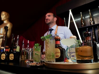 A bartender stands behind a counter with prepared drinks placed on it during a preview of the food, beverages and decor of this year's Governors Ball, the Academy's official post-Oscars celebration following the 94th Oscars ceremony in Los Angeles, California, U.S. March 24, 2022.
