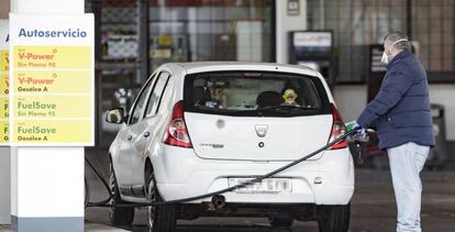 Un hombre reposta carburante en una estación de servicio.