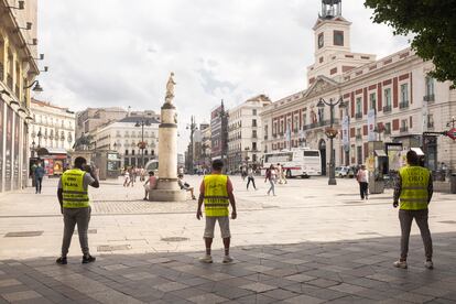Hombres anuncio de Compro Oro en la entrada a la Puerta del Sol de Madrid desde la calle del Arenal.