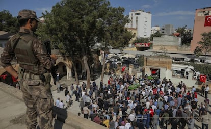 Un soldado turco vigila la marcha del funeral de dos vecinos de Suruç muertos a causa de un mortero lanzado desde Siria.