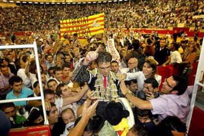 Bullfighter José Tomás is carried out of the Monumental bullring in Barcelona after the last bullfight ever in the plaza.
