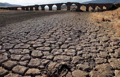 Part of the Guadiana river has dried up and gives way to dry land under the Puente de la Mesta medieval bridge in Villarta de los Montes, in the central-western Spanish region of Extremadura