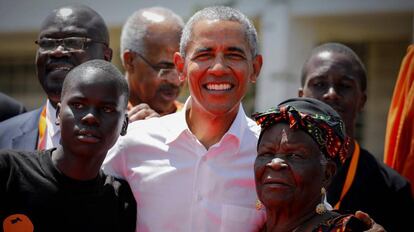 El expresidente estadounidense Barack Obama (c) posa junto a sus abuelastra Sarah Onyango Obama (dcha) y un estudiante (izq) en Kogelo, el pueblo de sus antepasados, a unos 400 kilómetros de Nairobi (Kenia). 