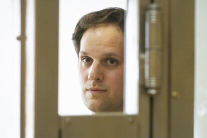 'Wall Street Journal' reporter Evan Gershkovich stands in a glass cage in a courtroom at the Moscow City Court in Moscow, Russia