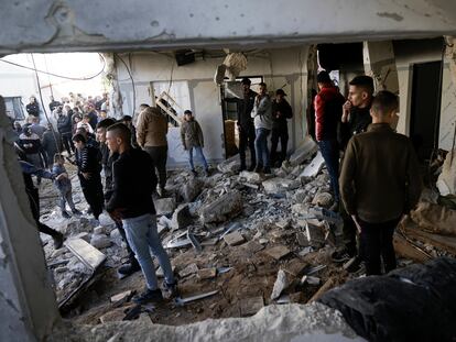 Palestinians look at the aftermath of an Israeli military raid on Jenin refugee camp in the West Bank on Wednesday, Nov. 29, 2023.