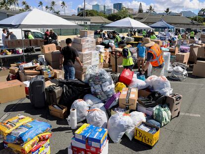 Hawaii stevedores and other volunteers prepare donations for the victims of the Maui wildfires at Pier 1, where they will ship them to Maui next week, in Honolulu, Hawaii, on August 12, 2023.