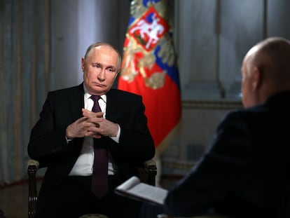 Russian President Vladimir Putin (L) attends an interview with Rossiya Segodnya International Media Group Director General Dmitry Kiselev at the Kremlin in Moscow, Russia, March 13, 2024.