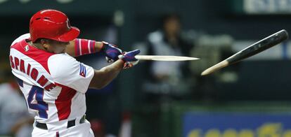 El cubano Alfredo Despaigne rompe su bate durante un partido de besibol entre Cuba y Japón, durante el primer clásico mundial de besibol en Fukuoka, Japón.