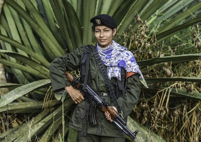 Rosmira, a member of the Revolutionary Armed Forces of Colombia (FARC), poses for a picture at a camp in the Colombian mountains on February 18, 2016. Many of these women are willing to be reunited with the children they gave birth and then left under protection of relatives or farmers, whenever the peace agreement will put an end to the country's internal conflict.    AFP PHOTO / LUIS ACOSTA