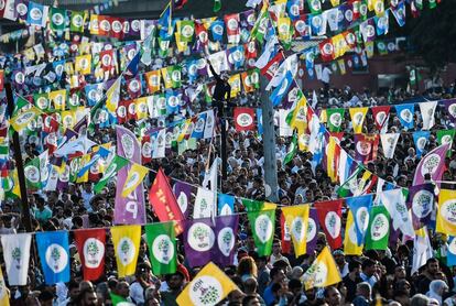 Los partidarios del preso Selahattin Demirtas, candidato a la presidencia de Turquía del Partido Democrático Popular (HDP), sostienen banderas turcas con una foto de Demirtas durante un acto electoral en Estambul.