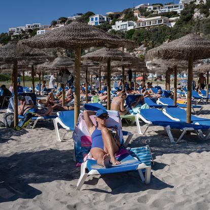 MENORCA, SPAIN - 2024/06/14: Beachgoers are seen at the En Porter beach sunbathing and relaxing. More than 90 million tourists are expected to visit Spain in 2024, a record-breaking number, making it the second most visited country in the world. (Photo by Davide Bonaldo/SOPA Images/LightRocket via Getty Images)