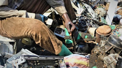 Trabajadores del vertedero de Agbogbloshie buscan piezas para reciclar. Los más privilegiados usan guantes para evitar cortes en las manos.