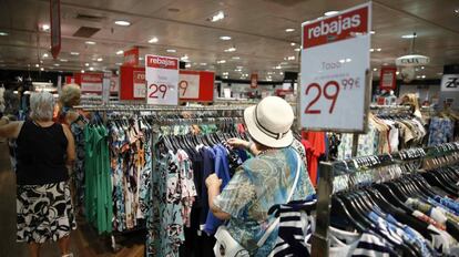 Varios clientes eligen entre los productos rebajados de un centro comercial en Madrid.