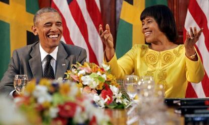 Obama shares a smile with Jamaican Prime Minister Portia Simpson-Miller during a stopover in Kingston before arriving in Panama.