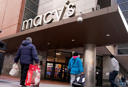 Shoppers walk to the Macy's store in the Downtown Crossing district