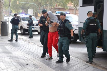 Dos agentes de la Guardia Civil escoltan a uno de los detenidos, este pasado jueves en Mallorca.