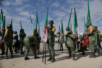 Elementos del Ejército Mexicano sostienen banderas durante la ceremonia de conmemoración de los 109 años de la institución, en febrero.