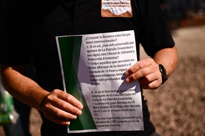 Fernando García, executive director of the NGO Red de la Frontera por los Derechos Humanos, holds up the flyer that was distributed to migrants on Tuesday urging them to surrender to border officials.