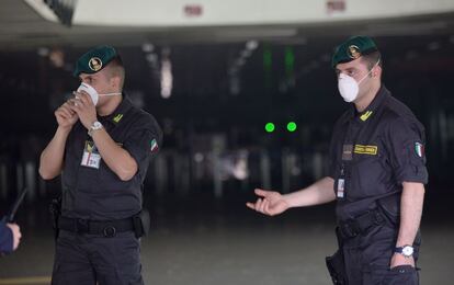 Las autoridades italianas pusieron en marcha un importante despliegue de seguridad en las inmediaciones del aeropuerto de Fiumicino tras declararse el incendio. El aeropuerto de Roma es el mayor de Italia, con 39 millones de pasajeros en 2014. En la imagen, dos agentes de la Guardia di Finanza controlan la entrada a la terminal 3.