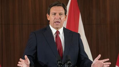 Florida Gov. Ron DeSantis listens to others during a news conference where he spoke of new law enforcement legislation that will be introduced during the upcoming session, Jan. 26, 2023, in Miami.
