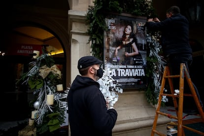 Dos trabajadores decoran la fachada del Gran Teatre del Liceu.