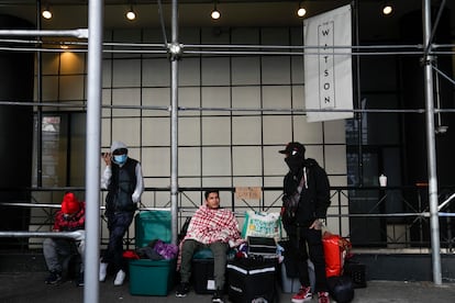 Migrants camp with their belongings on the sidewalk in front of the Watson Hotel in New York, on Jan. 30, 2023.