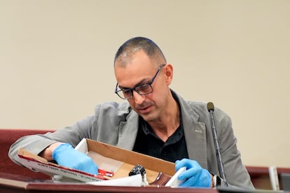 Alessandro Pietta examining the revolver that he manufactured in 2017.