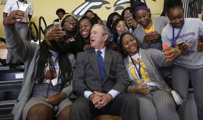 El expresidente de los Estados Unidos, George W. Bush, posa para una foto con estudiantes en un colegio de Nueva Orleans.