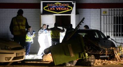 Miembros de la policía científica buscan restos en el bar.