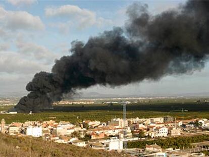 La espesa columna de humo, en la mañana de ayer, sobre la comarca de La Ribera. En primer plano, la localidad de Manuel.