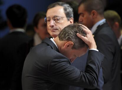 El secretario de Tesoro de EE UU, Timothy Geithner (delante) y el nuevo presidente del Banco Central Europeo, Mario Draghí, llegan para las reuniones de la segunda jornada de la cumbre del G-20 en Cannes.