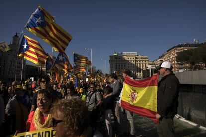 A Spanish flag is held up as Catalan protesters march by in Madrid.
