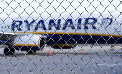 Un avión de la compañía Ryanair es visto detrás de una valla mientras está estacionado en la pista del aeropuerto Weeze cerca de la frontera germano-holandesa.