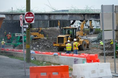 Crews continue to work the scene of a collapsed elevated section of Interstate 95, in Philadelphia