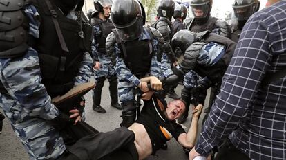 Membros da polícia prendem um dos participantes da manifestação opositora em Moscou.