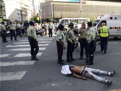  La polic&iacute;a rodea el cuerpo de un hombre asesinado en Caracas, en 2012