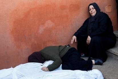 A woman cries next to the bodies of several Palestinians killed in Israeli attacks on Khan Younis, in the south of the Gaza Strip.