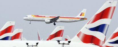 Un avión de Iberia vuela sobre aeronaves de British Airways el pasado marzo en el aeropuerto londinense de Heathrow.