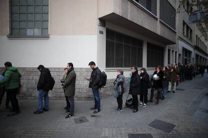 Gent fent cua per votar abans que obri el col·legi electoral de l'Institut Jaume Balmes, a Barcelona.