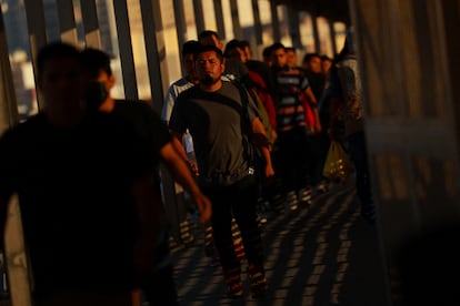 Migrants deported from the U.S. walk towards Mexico at the Paso del Norte International border bridge, as seen from Ciudad Juarez, Mexico