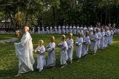 A Buddhist nun walks in line with novice nuns to receive food from people during the Songkran Festival at the Sathira-Dhammasathan Buddhist meditation centre in Bangkok, Thailand, April 13, 2016. REUTERS/Athit Perawongmetha